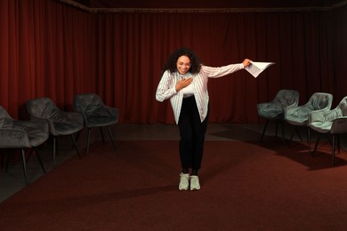 Photo of Professional actress bowing on stage in theatre