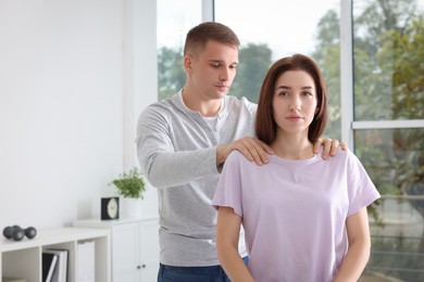 Photo of Osteopath working with patient in clinic. Manual therapy