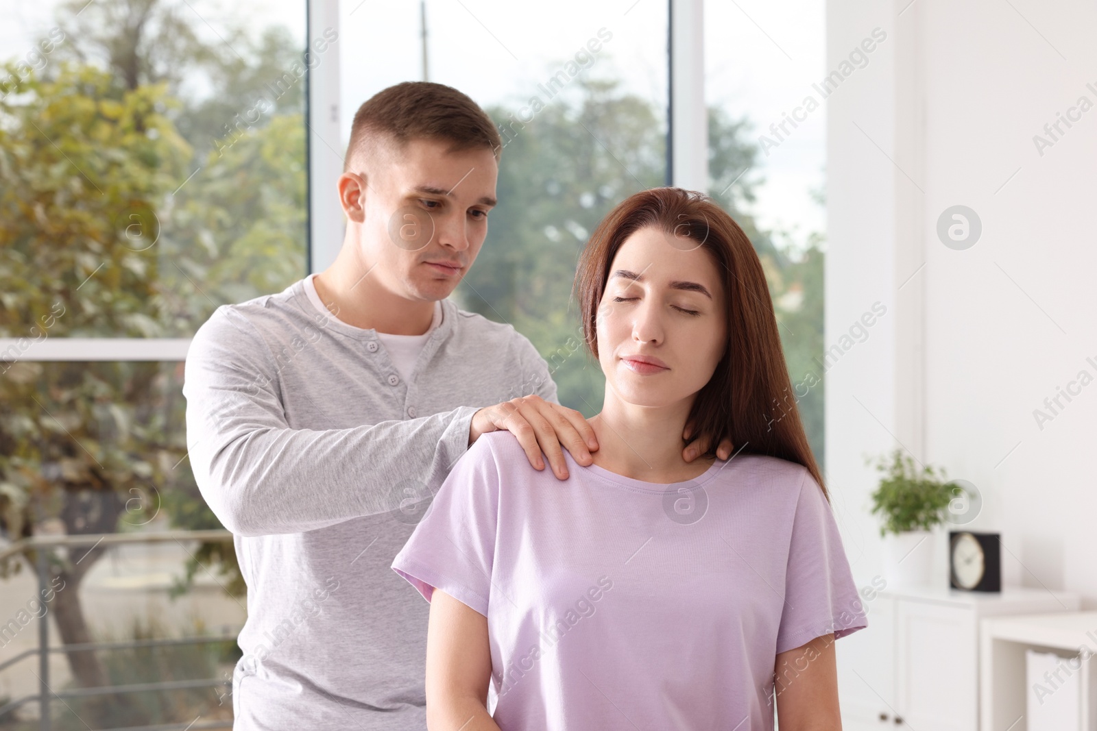 Photo of Osteopath working with patient in clinic. Manual therapy