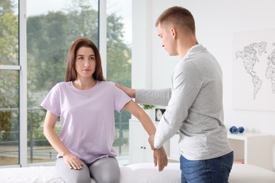 Photo of Osteopath working with patient in clinic. Manual therapy