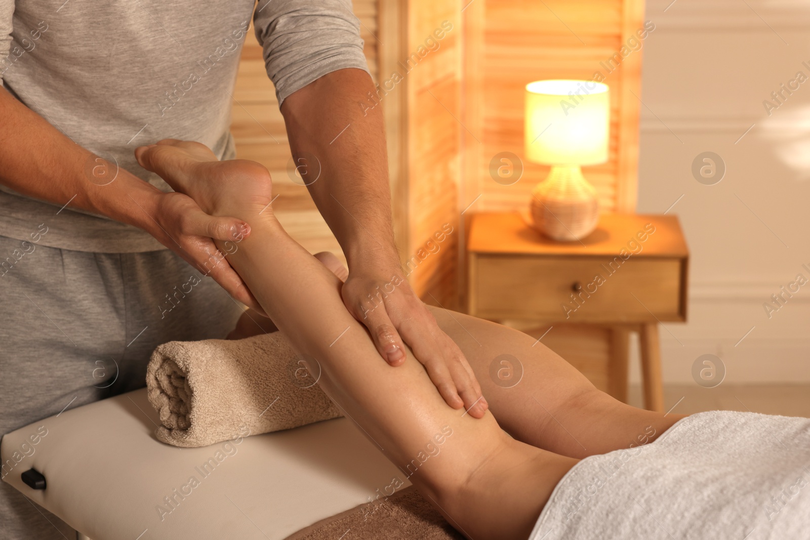 Photo of Osteopath working with patient indoors, closeup. Manual therapy