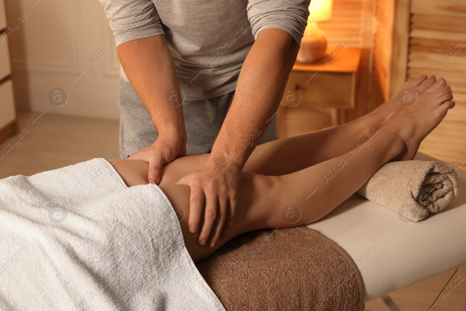 Photo of Osteopath working with patient indoors, closeup. Manual therapy