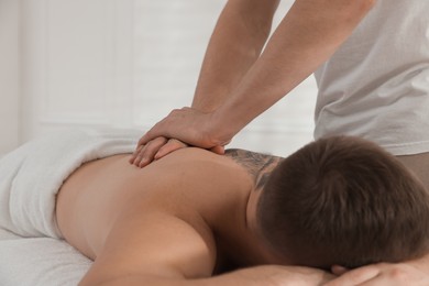 Photo of Massage therapist working with patient in clinic, closeup