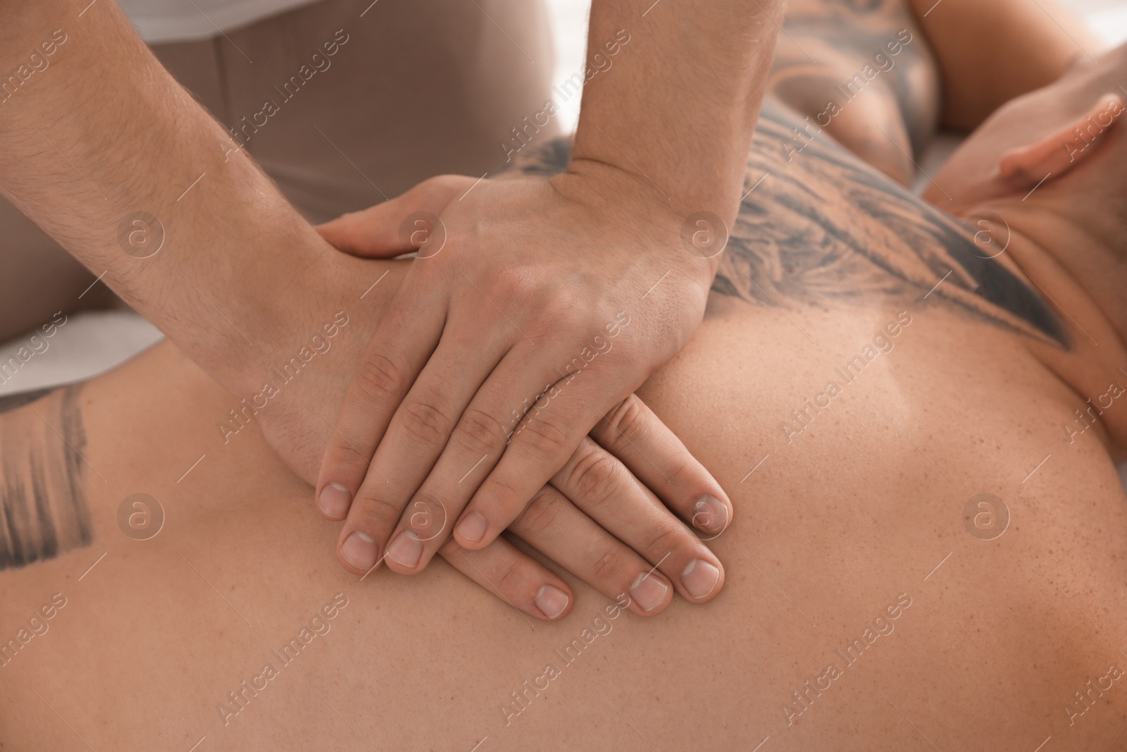 Photo of Massage therapist working with patient in clinic, closeup