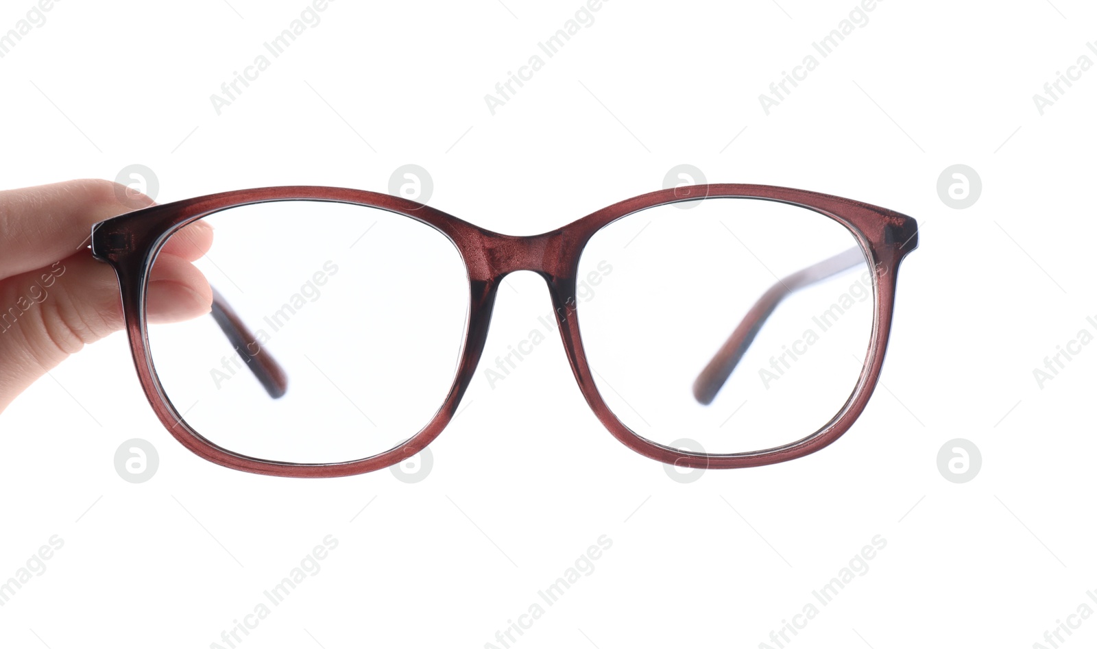 Photo of Woman holding glasses with brown frame on white background, closeup