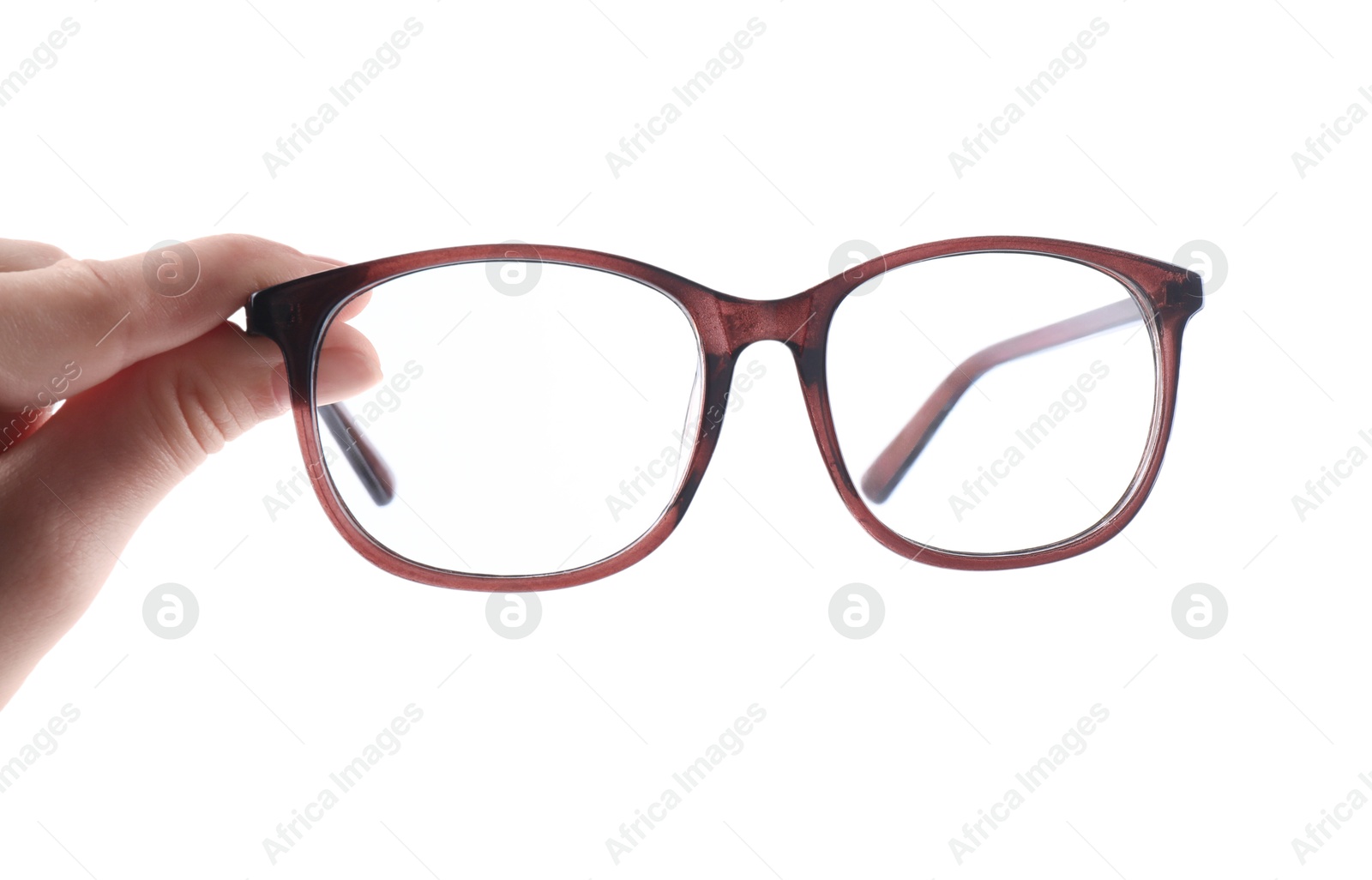 Photo of Woman holding glasses with brown frame on white background, closeup