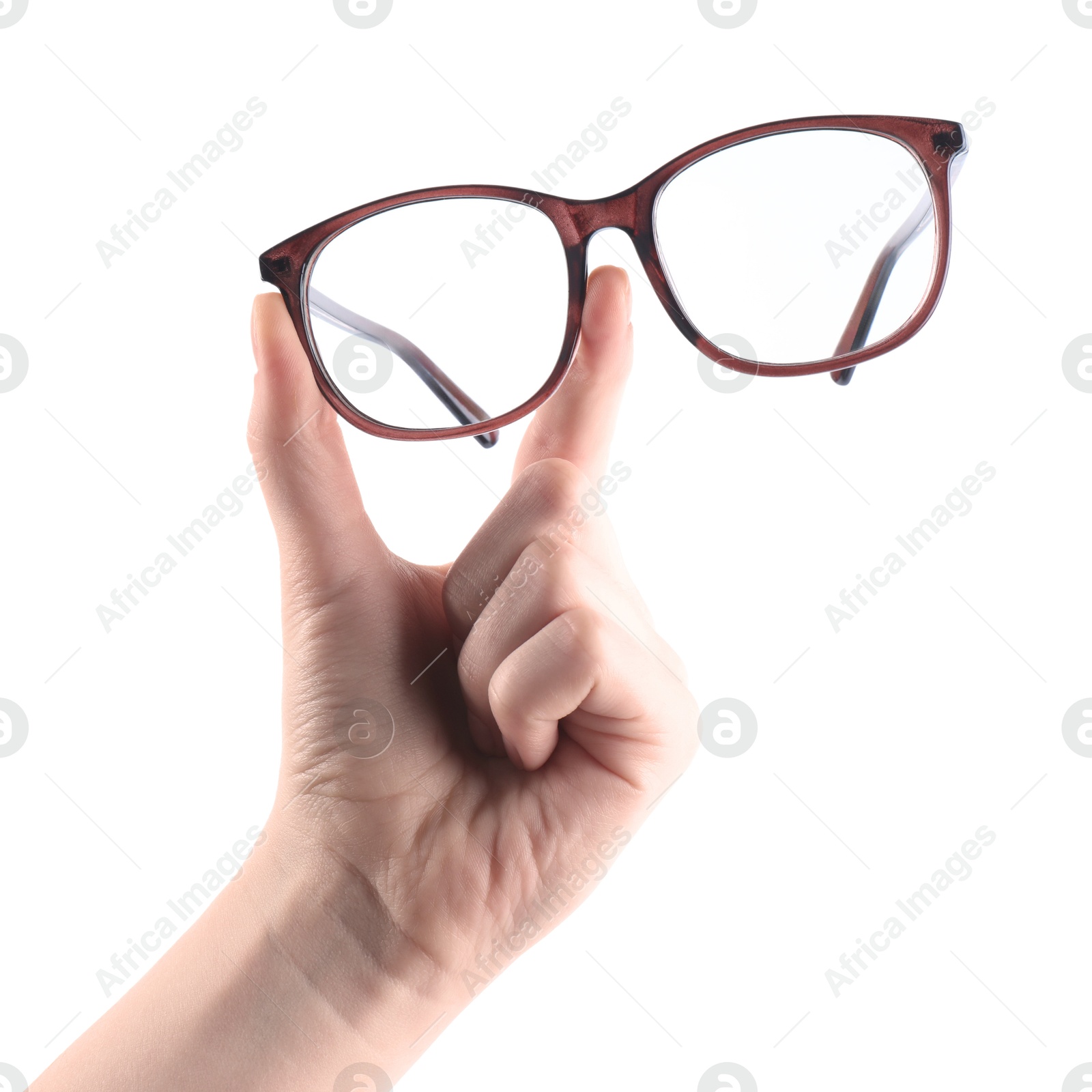 Photo of Woman holding glasses with brown frame on white background, closeup