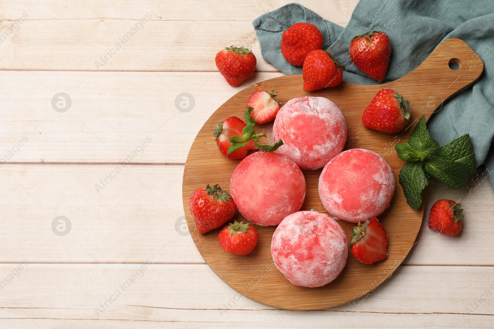 Photo of Delicious mochi, strawberries and mint on wooden table, flat lay. Space for text