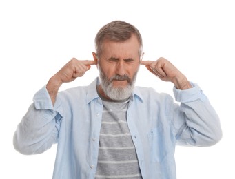 Photo of Senior man covering his ears with fingers on white background