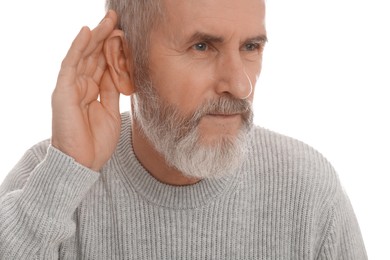 Photo of Senior man showing hand to ear gesture on white background