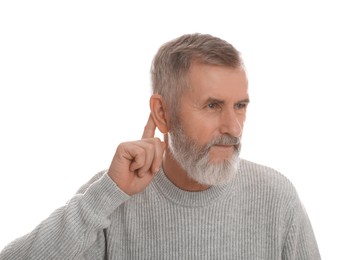 Photo of Senior man showing hand to ear gesture on white background