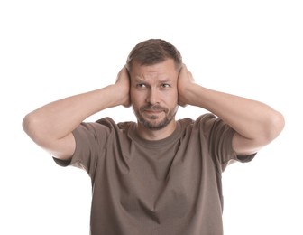 Photo of Man covering his ears on white background