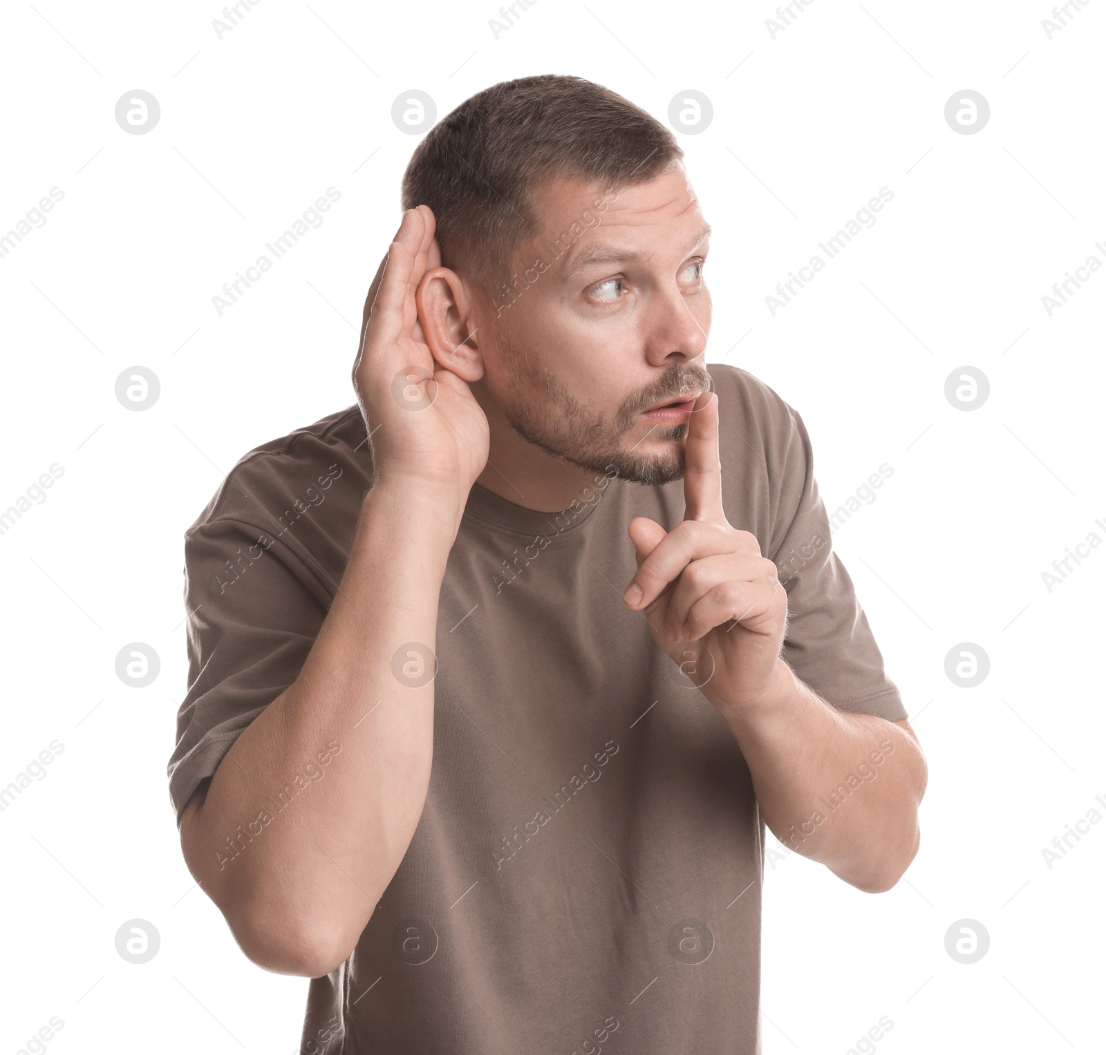 Photo of Man showing hand to ear gesture on white background