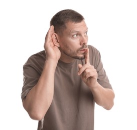 Photo of Man showing hand to ear gesture on white background