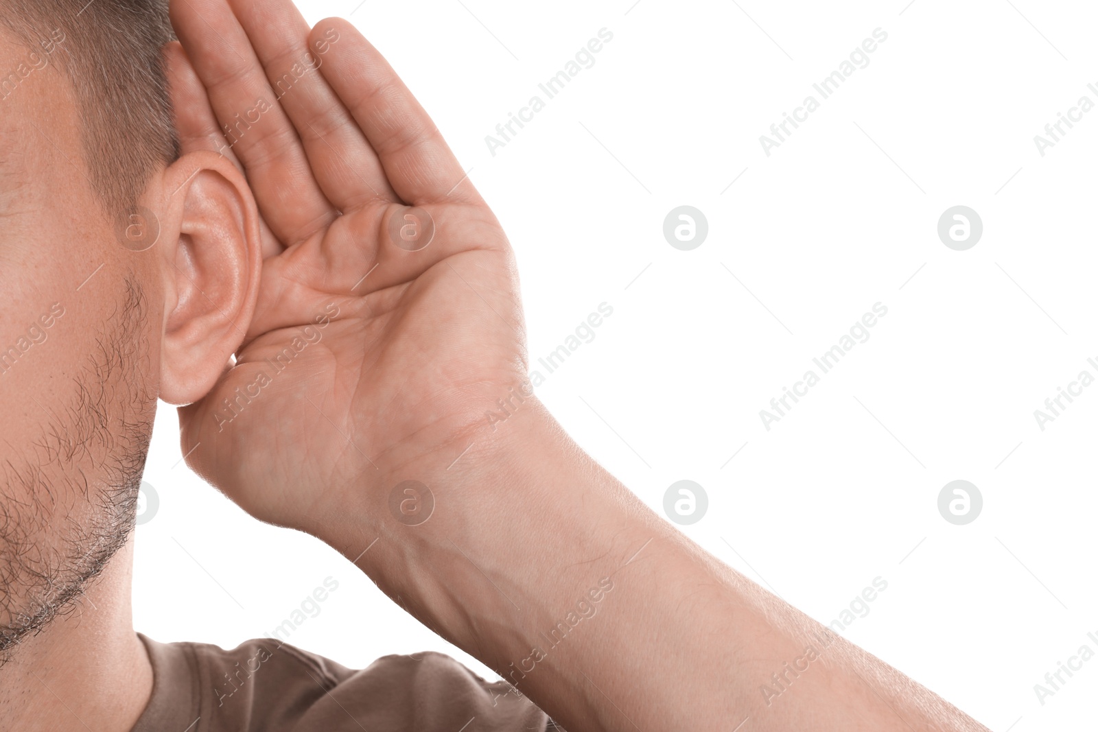 Photo of Man showing hand to ear gesture on white background, closeup