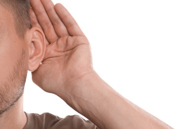 Photo of Man showing hand to ear gesture on white background, closeup