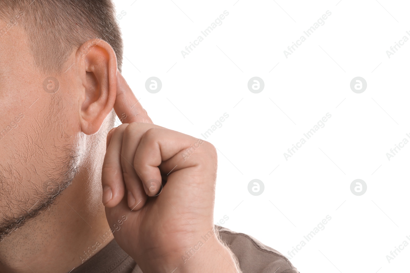 Photo of Man showing hand to ear gesture on white background, closeup