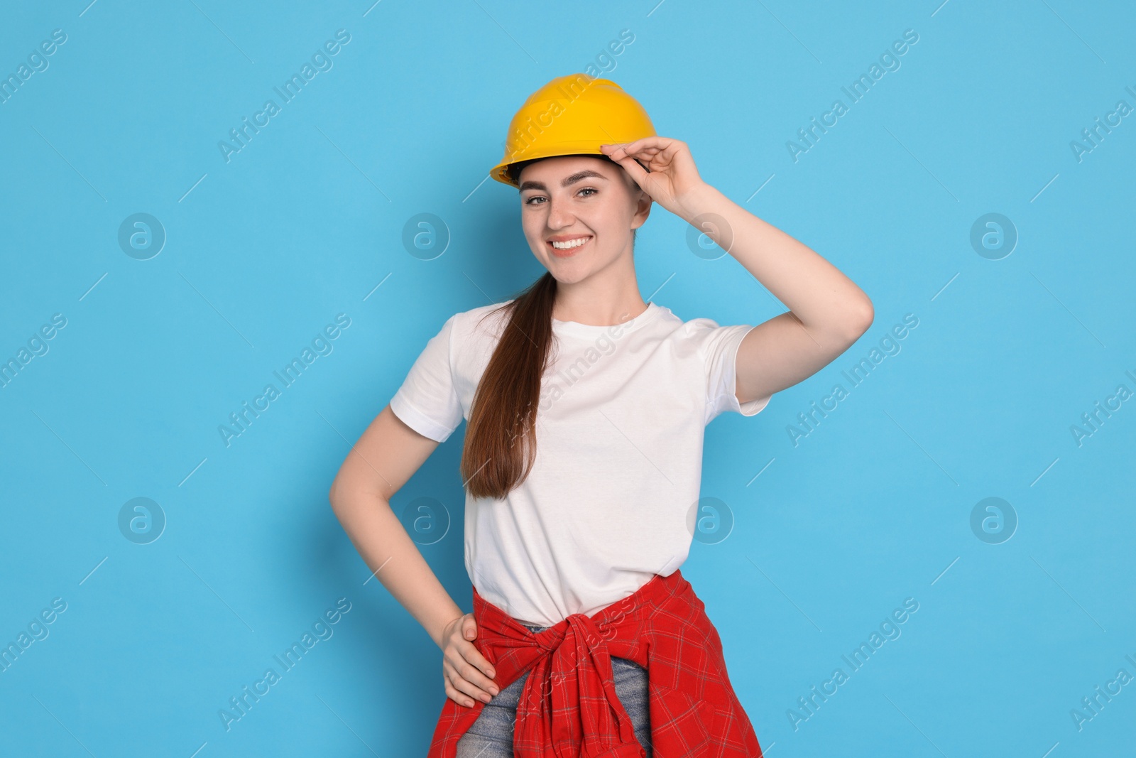 Photo of Portrait of young decorator on light blue background