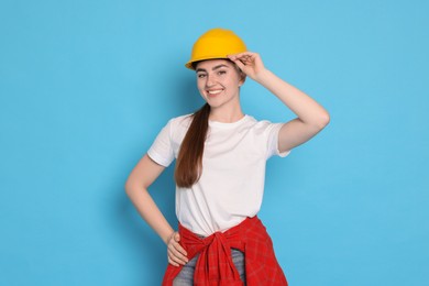 Portrait of young decorator on light blue background