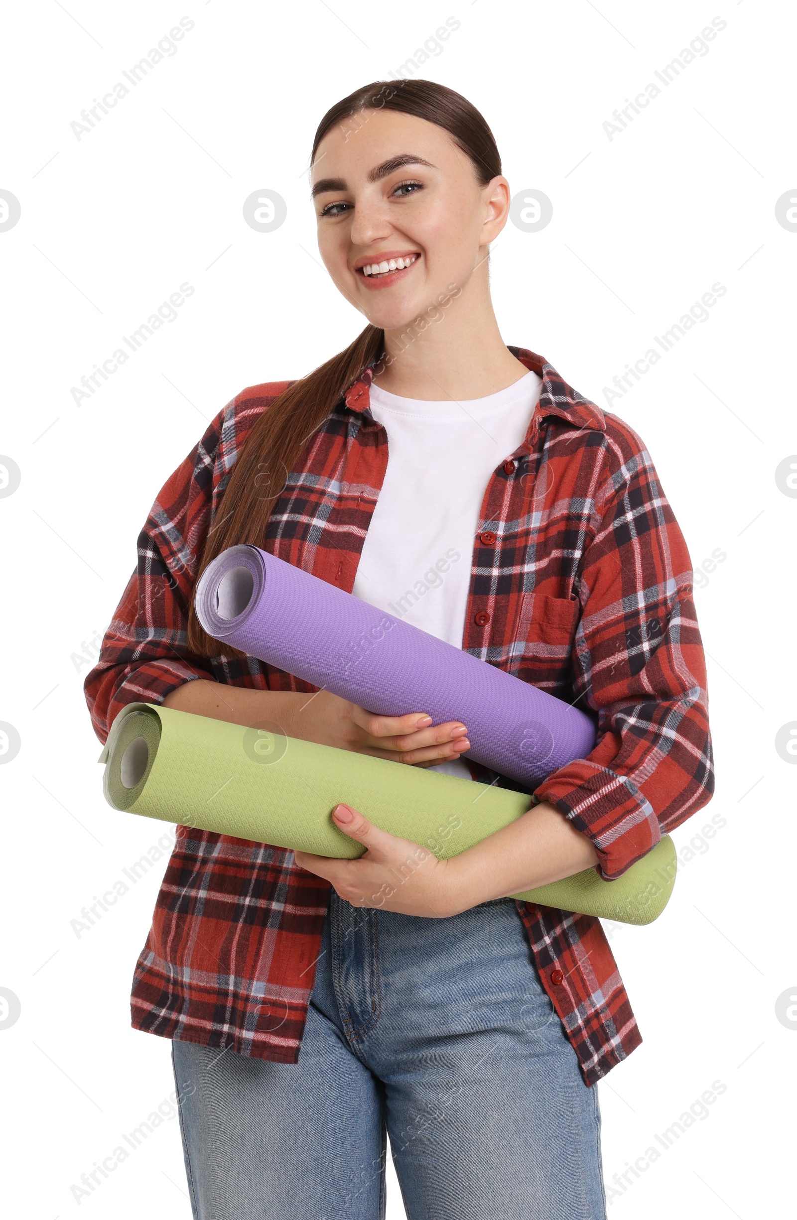 Photo of Young decorator with rolls of wallpaper on white background