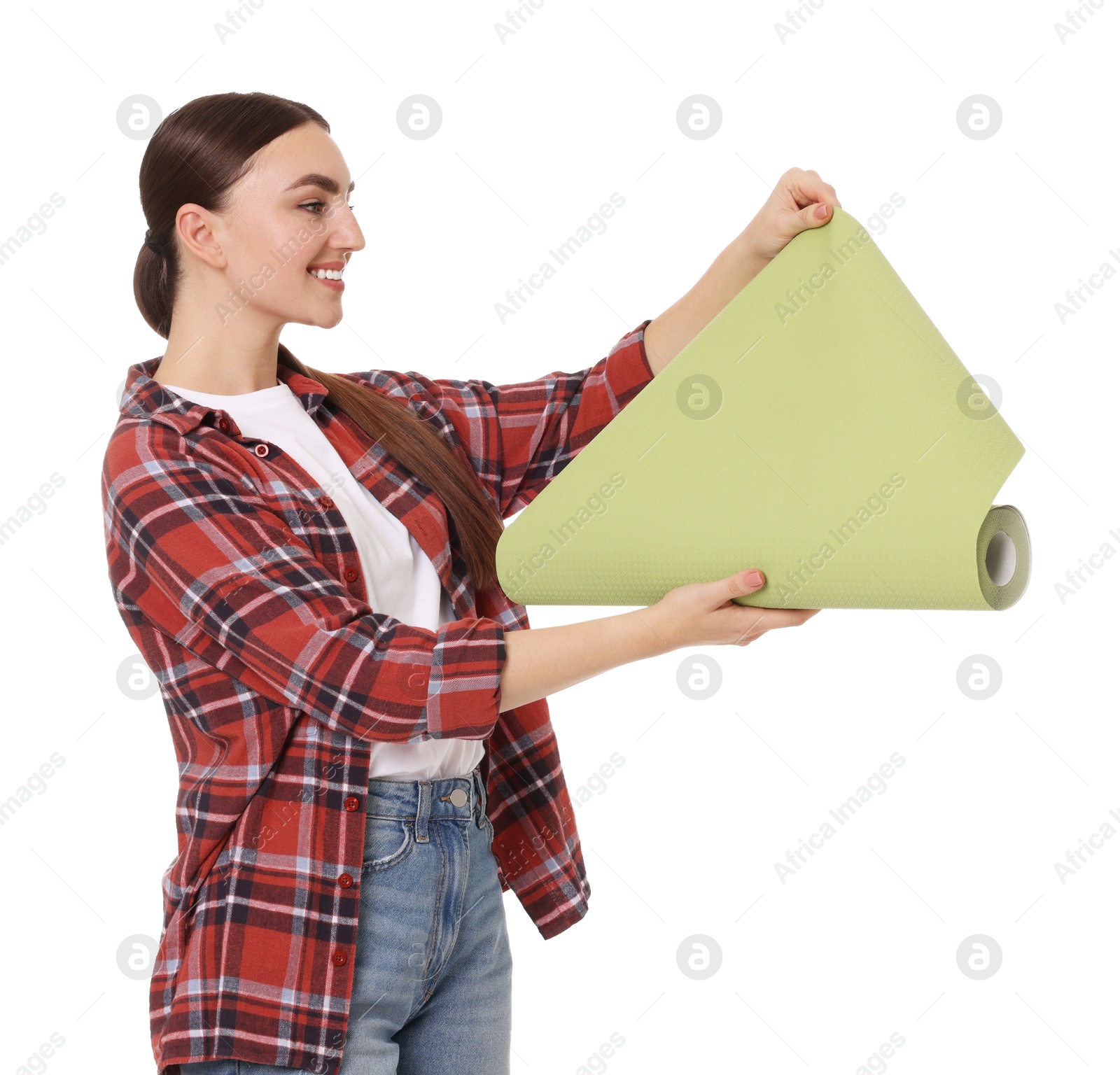 Photo of Young decorator with roll of wallpaper on white background