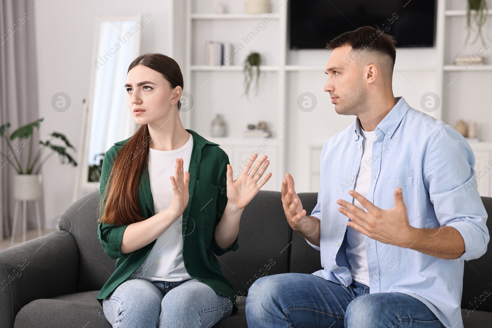 Photo of Upset woman ignoring her husband at home