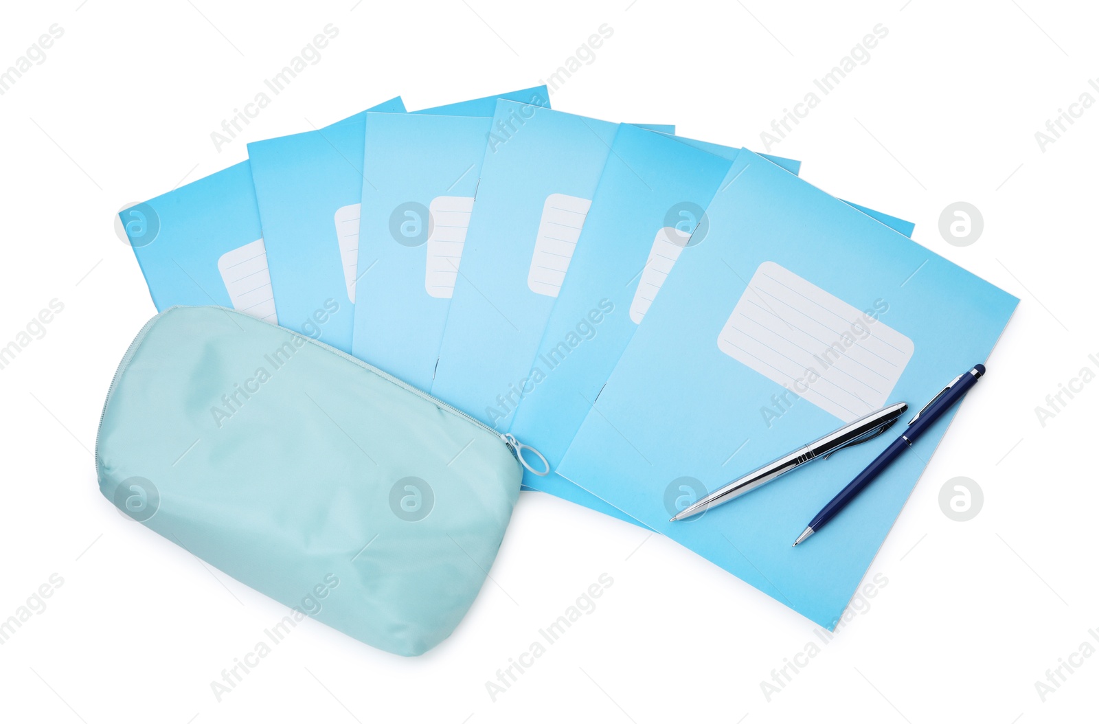 Photo of Copybooks, pencil case and pens isolated on white, top view. School stationery