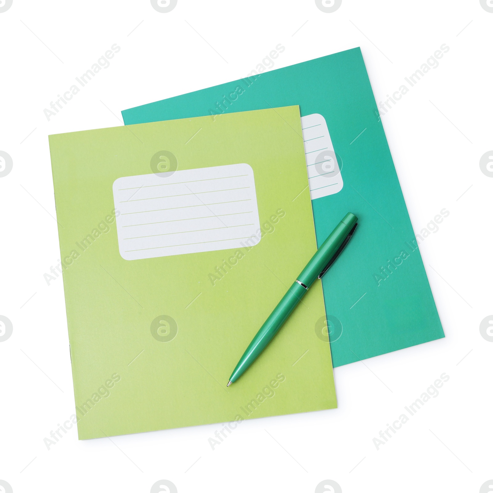 Photo of Copybooks and pen isolated on white, top view. School stationery