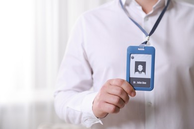 Photo of Doctor with badge in hospital, closeup. Space for text