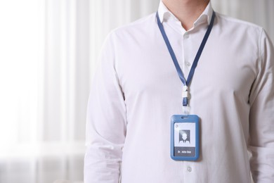 Photo of Doctor with badge in hospital, closeup. Space for text