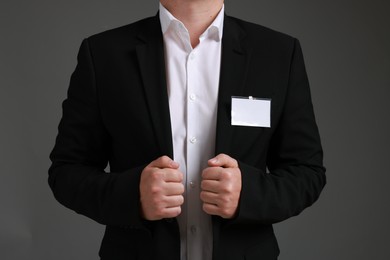 Photo of Man with blank badge on gray background, closeup