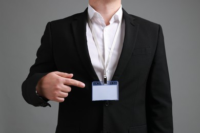 Photo of Man with blank badge on gray background, closeup