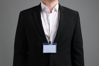 Photo of Man with blank badge on gray background, closeup