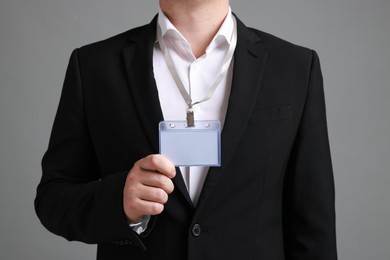 Photo of Man with blank badge on gray background, closeup