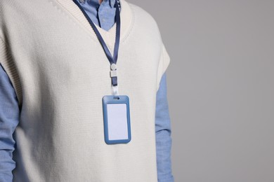 Photo of Man with blank badge on gray background, closeup. Space for text