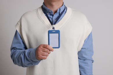 Photo of Man with blank badge on gray background, closeup