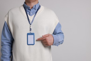 Photo of Man with blank badge on gray background, closeup. Space for text