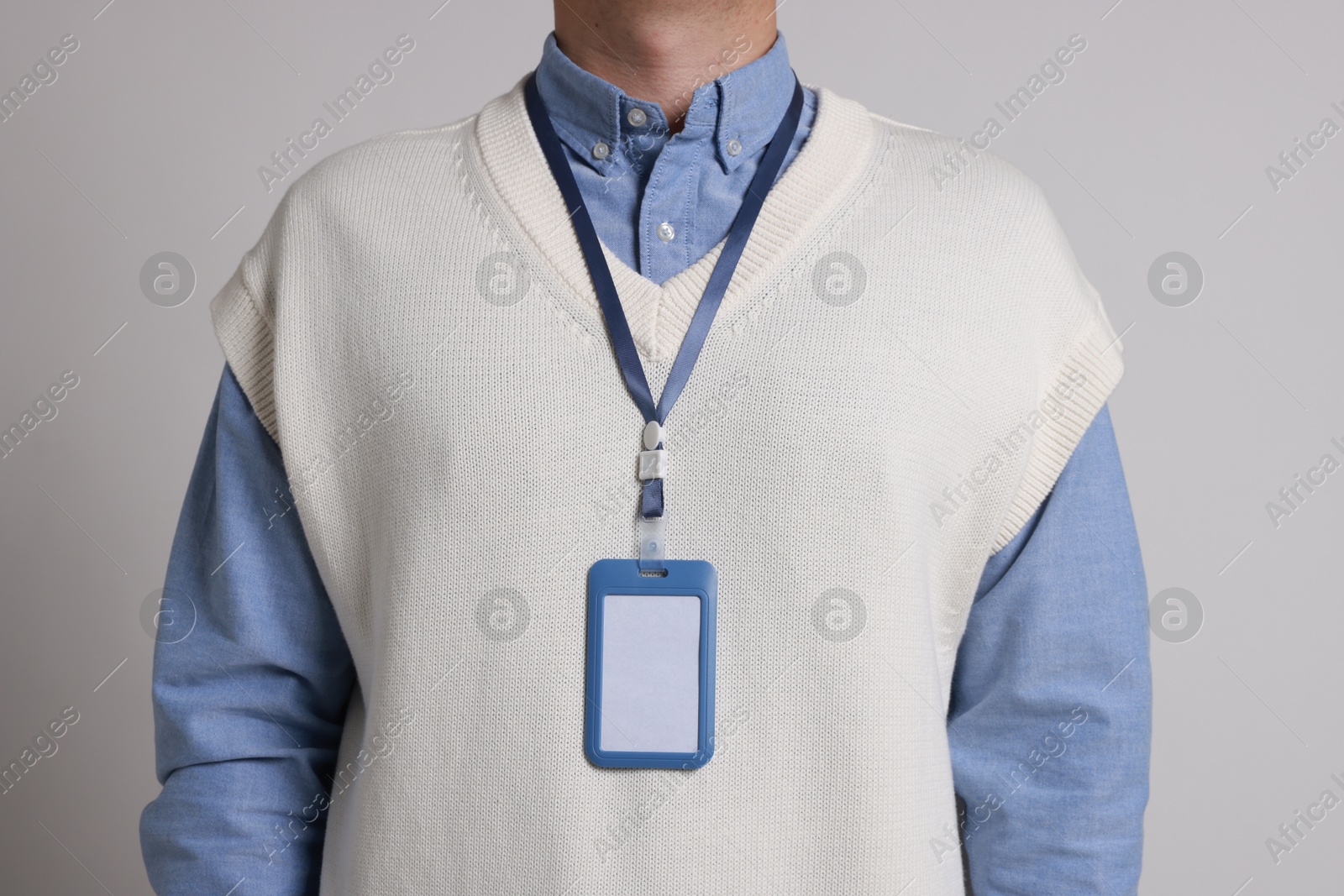 Photo of Man with blank badge on gray background, closeup