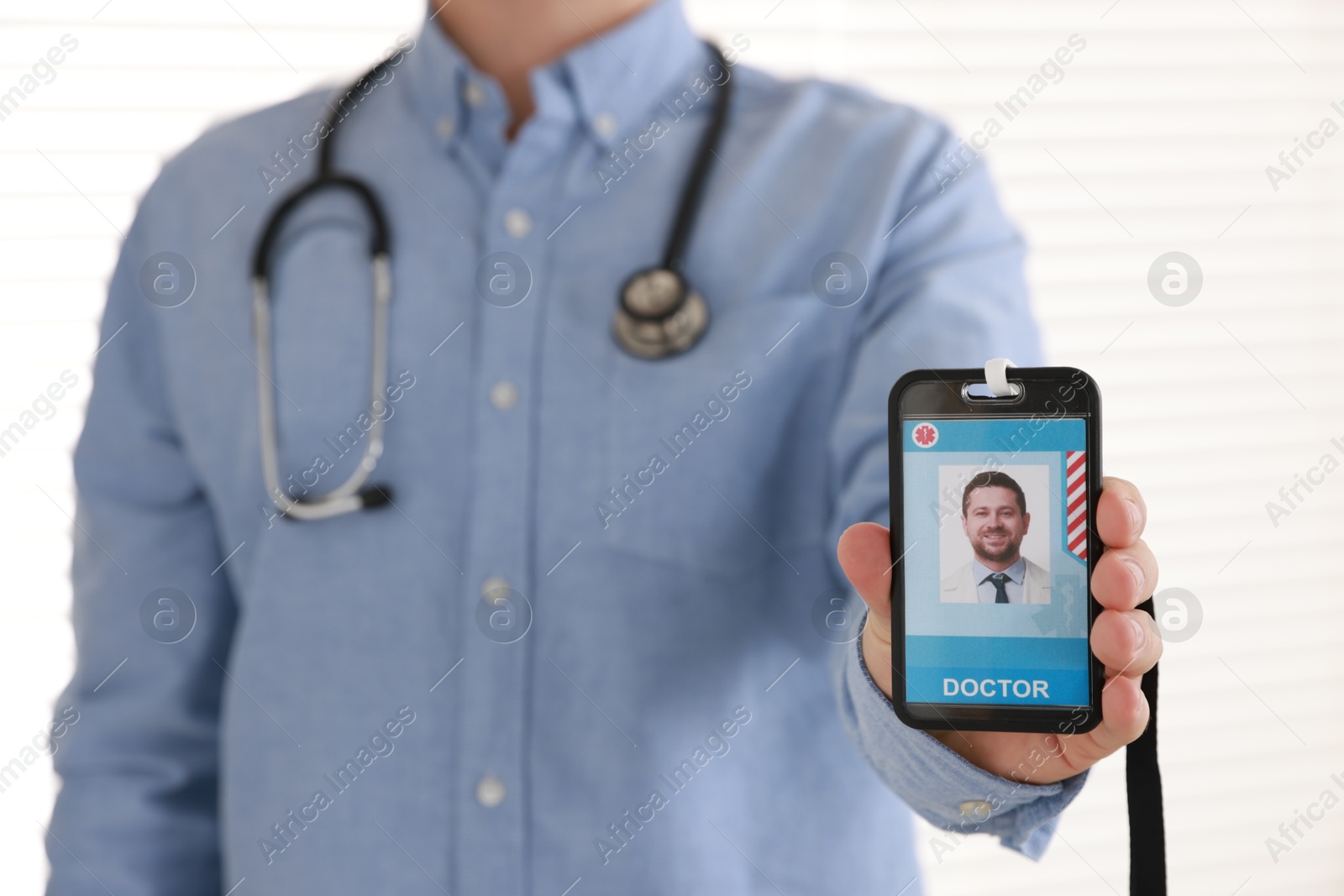 Photo of Doctor with badge in hospital, closeup view