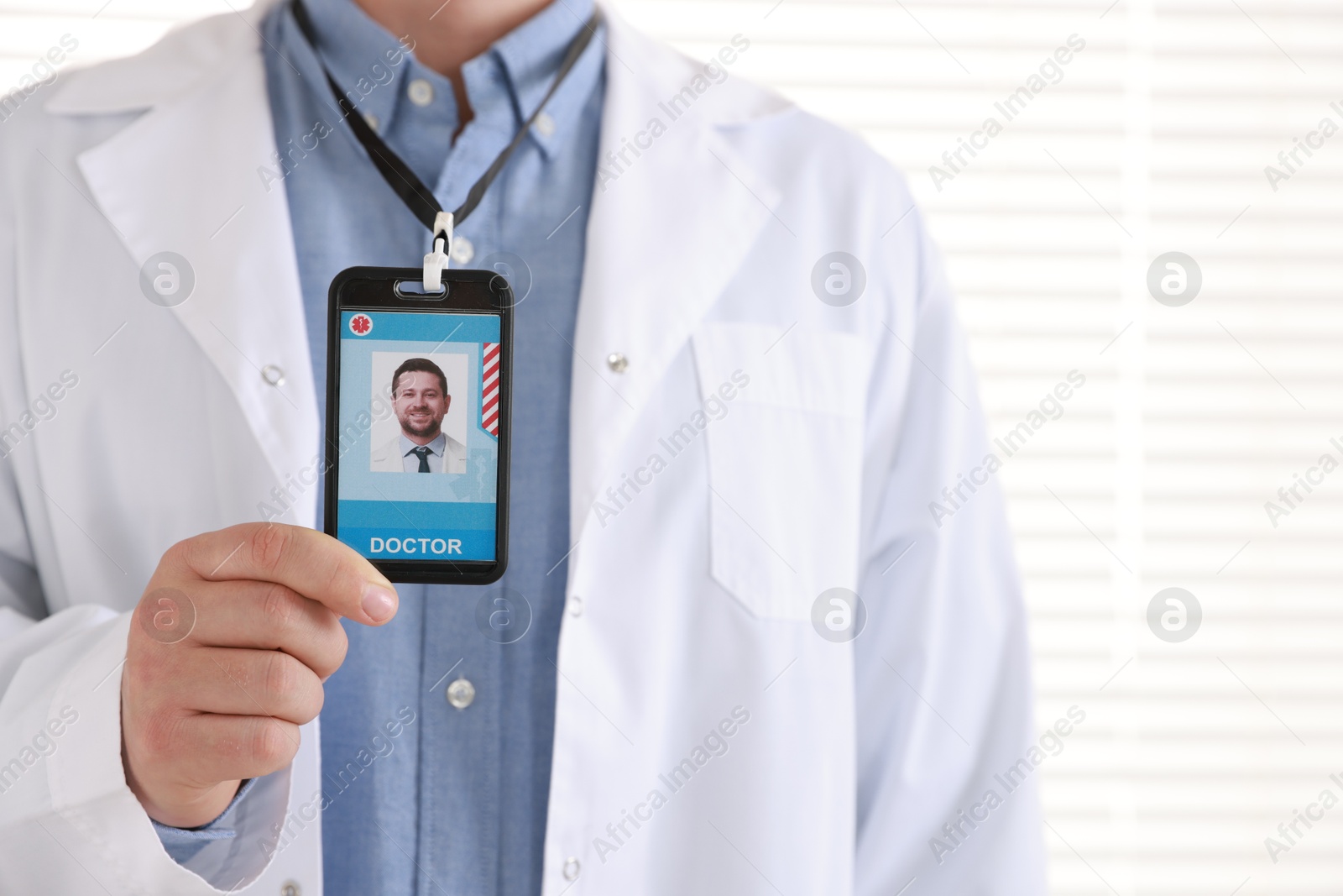 Photo of Doctor with badge in hospital, closeup view