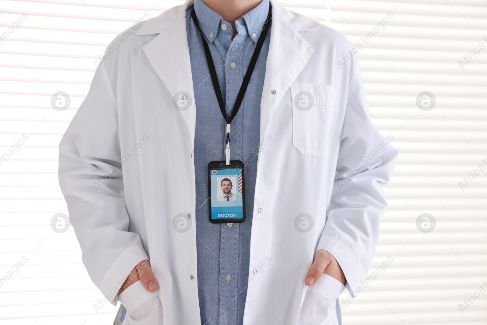 Photo of Doctor with badge in hospital, closeup view