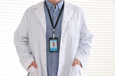 Photo of Doctor with badge in hospital, closeup view