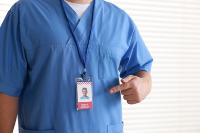 Photo of Medical assistant with badge in hospital, closeup