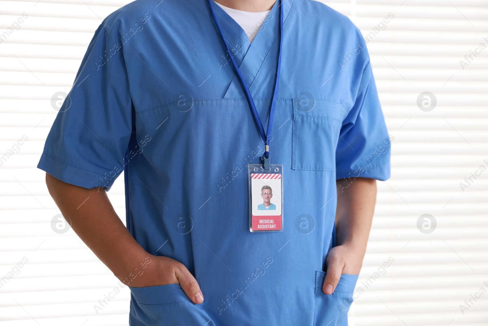 Photo of Medical assistant with badge in hospital, closeup