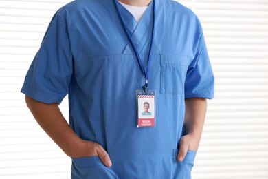 Photo of Medical assistant with badge in hospital, closeup