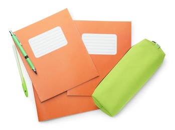 Photo of Copybooks, pencil case and pens on white background, top view