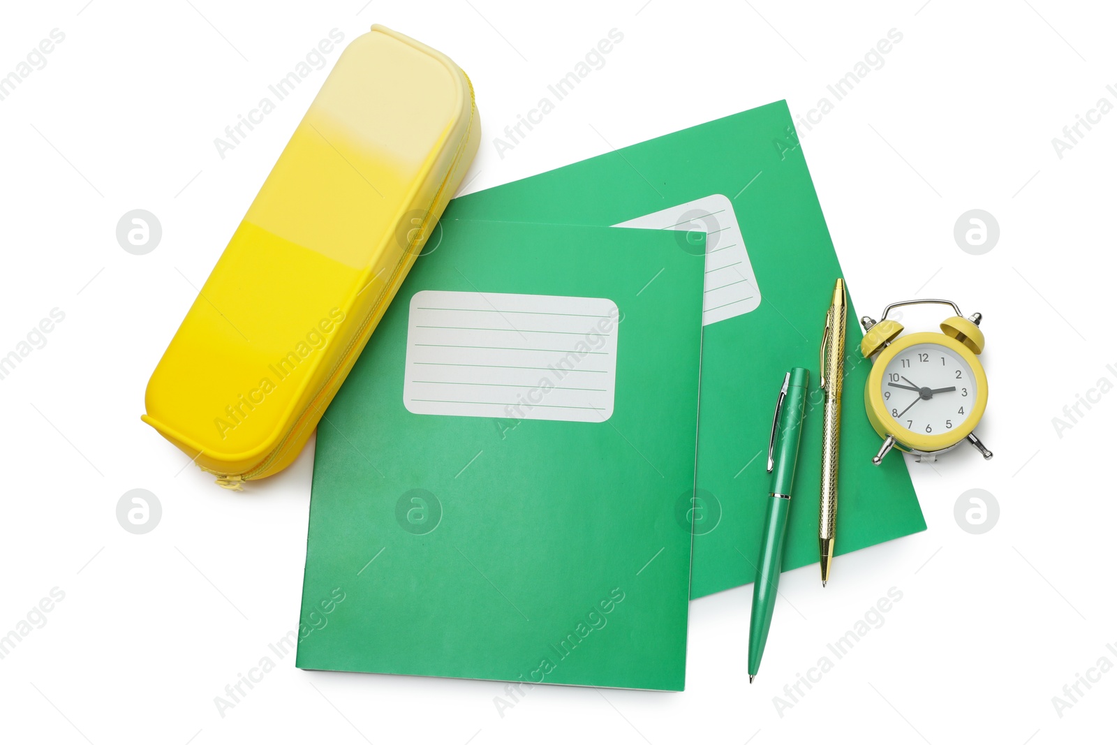 Photo of Copybooks, pencil case, pens and alarm clock on white background, top view