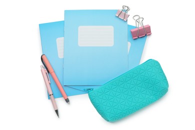 Photo of Copybook and other school stationery on white background, top view