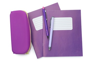 Photo of Purple copybooks, pencil case and pens on white background, top view