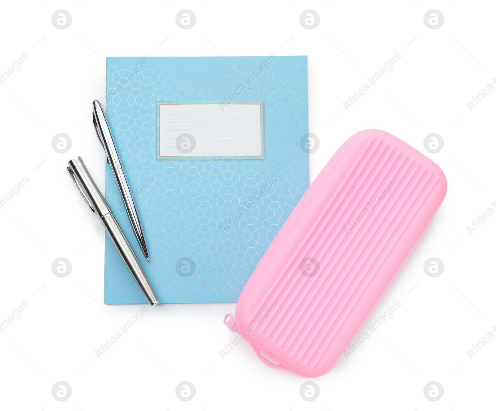 Photo of Copybook, pencil case and pens on white background, top view